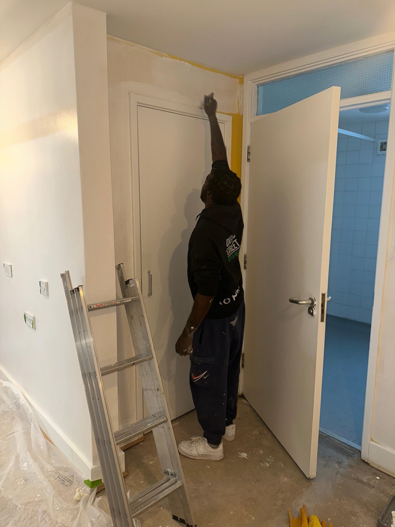 Decorator cutting in along a ceiling line